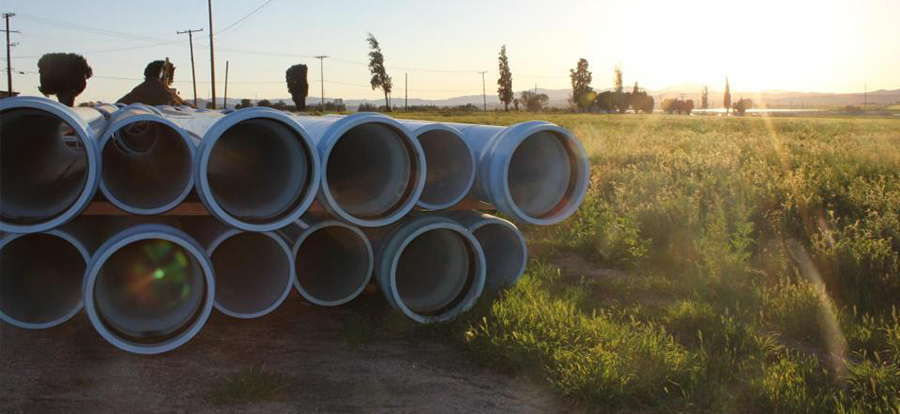 Sewer pipes stacked in a field